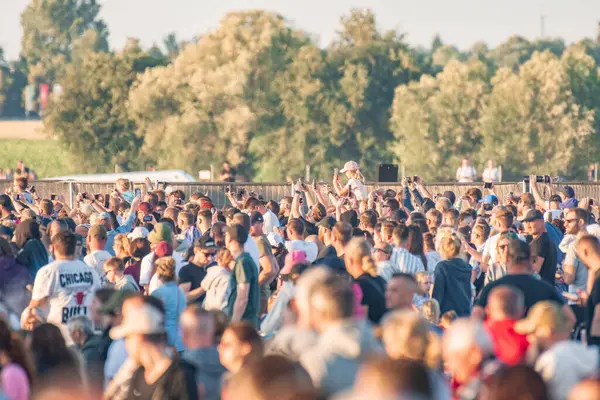 stock image Leszno, Poland - June, 22, 2024: Antidotum Airshow Leszno. A large audience gathered at the airport on the second day of the air show, all admiring the acrobatics of planes in the sky.