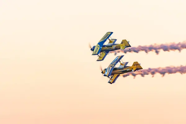 stock image Leszno, Poland - June, 22, 2024: Antidotum Airshow Leszno, Scandinavian Airshow, Viking model 12-S plane. An acrobatic team performs an evening show after sunset, spectacular smoke behind the plane.