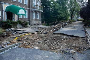 Ladek Zdroj, Poland - September, 17, 2024: Destroyed street and city infrastructure after a rushing river, two days after the flood wave passed through the city. View from Paderewskiego Street. clipart