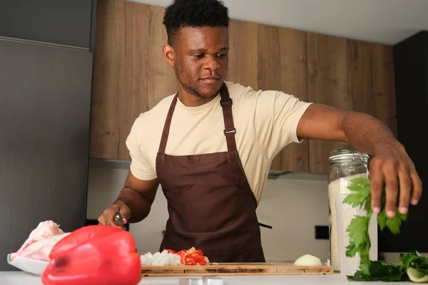 Young African Man Grabbing Celery Prepare Chicken Recipe Kitchen — Stock Photo, Image