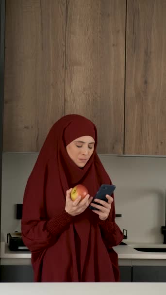 Muslim Young Woman Hijab Drinking Coffee Using Smartphone Kitchen Home — Stockvideo