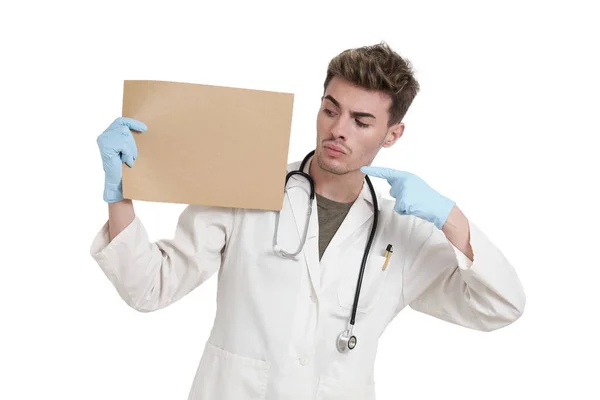 Young Caucasian Male Serious Doctor Pointing Board Isolated White Background — Zdjęcie stockowe