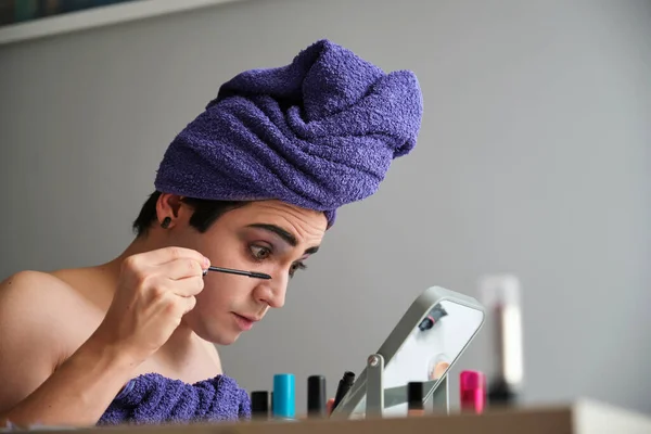 Young Transgender Man Applying Eye Mascara Shower Towel His Head — Stockfoto