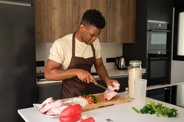 Young Black Man Removing Skin Chicken Prepare Recipe Kitchen — Stock Photo, Image