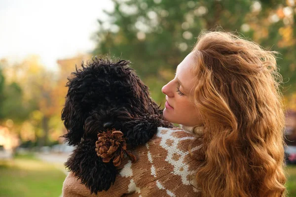 Young Woman Hugging Her Black Puppy Poodle Dog Park Autumn — Zdjęcie stockowe