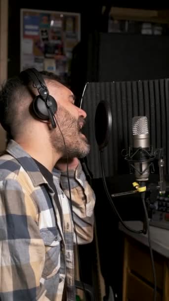 Male Singer Wearing Headphones Performing New Single Microphone Recording Music — Stock Video