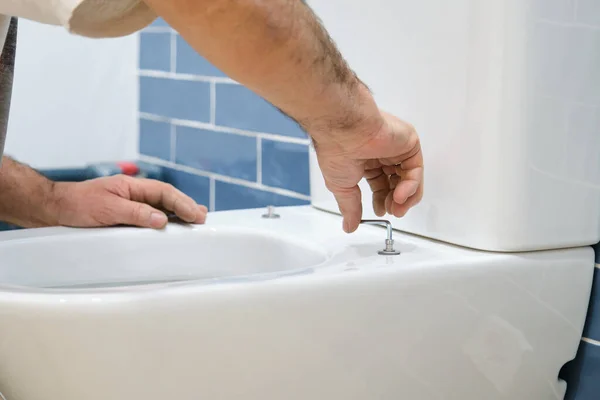 Unrecognizable Senior Plumber Installer Installing Toilet Lid Bathroom Stock Image
