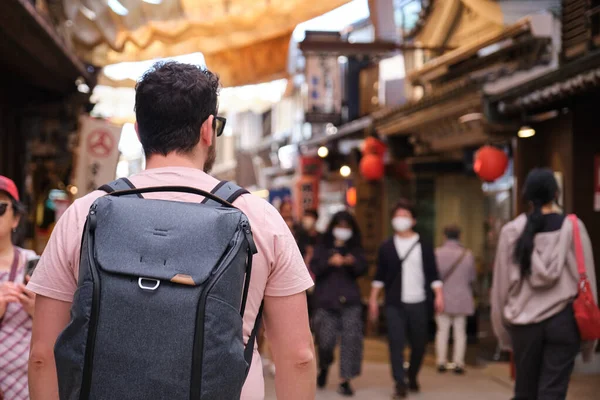 stock image European tourist visiting a traditional japanese street in Miyajima, Hiroshima, Japan.