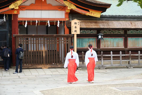 stock image Kyoto, Japan. April 24, 2023: Two miko or shrine maiden at Yasaka-jinja Shinto Shrine in Kyoto, Japan.
