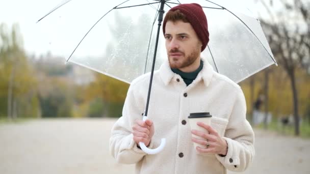 Young Man Coffee Transparent Umbrella Looking Camera Smiling Winter — Stock Video