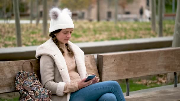 Preteen Girl Two Braids Backpack Taking Selfie Smartphone Sitting Bench — Vídeo de Stock