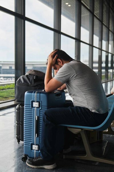 Desperate man at Narita airport, upset because his flight was delayed.