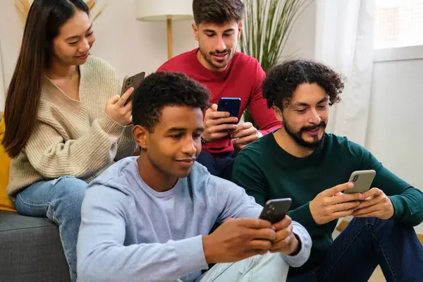Multiracial group of friends using the smartphone at home.