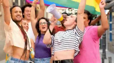 Gökkuşağı bayraklı LGBTQ insanları ve hakları için savaşan bir megafon. Hepsi gülümsüyor ve Onur Yürüyüşü 'nü kutluyor..