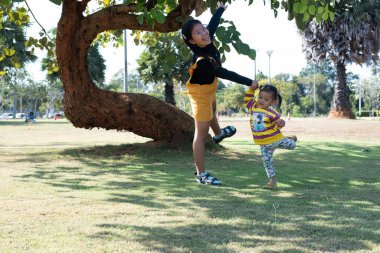 Asian family having fun in the garden Mother and daughter having fun together.