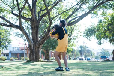 Asian family having fun in the garden Mother and daughter having fun together.