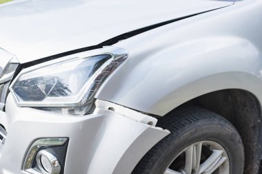 The front of a white car was damaged in a road accident. clipart