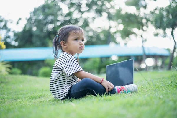 stock image Happy asian family picnic. Daughters playing mobile phones and laptops having fun together while sitting alone on sunny day.