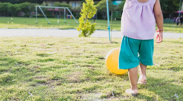 Beautiful Little Girl Picking Yellow Ball Lawn Sun Setting Sport — Stock Photo, Image