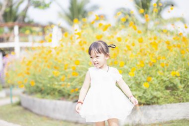 woman in a field with flowers- freedom, active, happiness concept