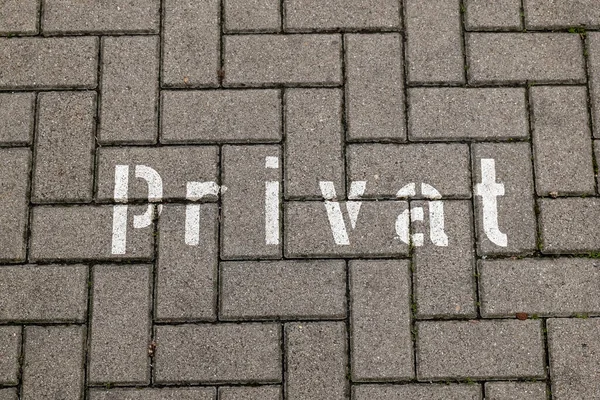 paving stones with the german word private with view from above
