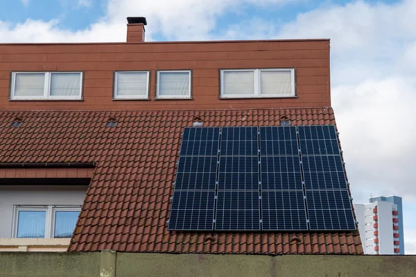 black solar cells on a roof of a residential house