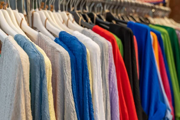 stock image colorful dresses on clothes hooks in a fashion store