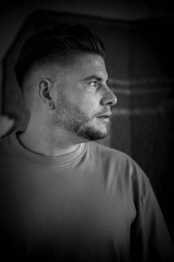 Siyah beyaz sakallı bir gencin portresi.