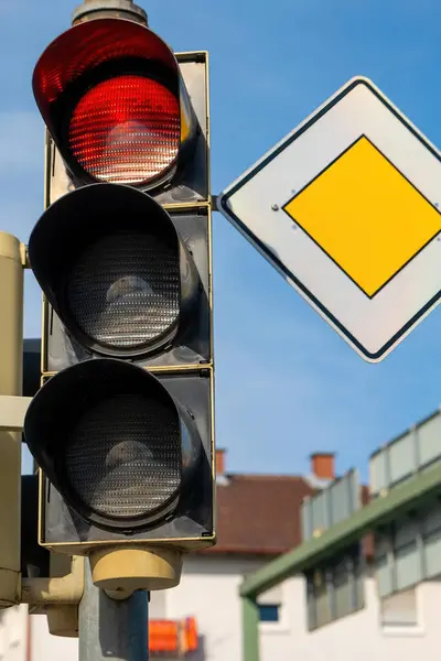 a traffic light is red and yellow sign in the background
