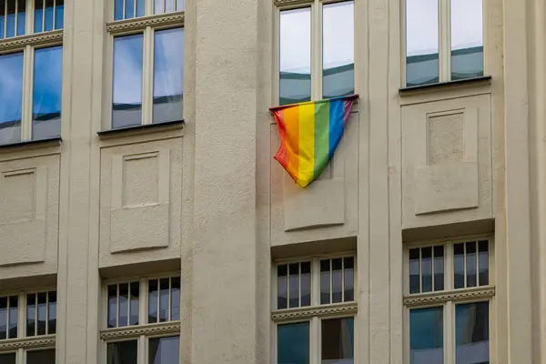 stock image a rainbow flag hanging from a window as a sign of tolerance