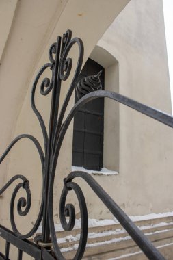 Eski dövülmüş siyah demir kapı. Kemerdeki ortaçağ binasına giriş mimarisinin ayrıntıları. Duvarlar arasında güzel çelik desenler var. Eski çıkış.