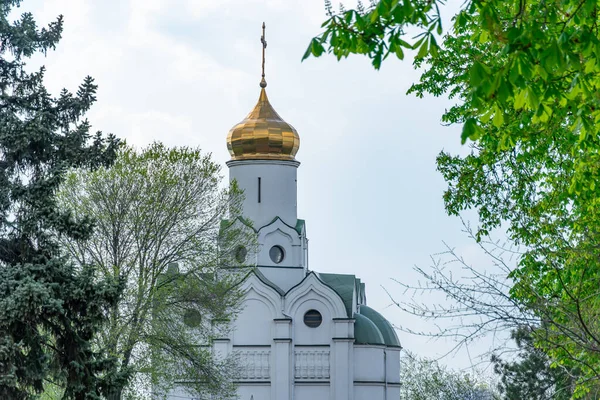 Stock image Church saint Nicholas with golden domes and place religion of orthodox christian. Built structure for prayer in modern city. Landscape with green park in middle of river. Monastyrsky island in Dnipro.