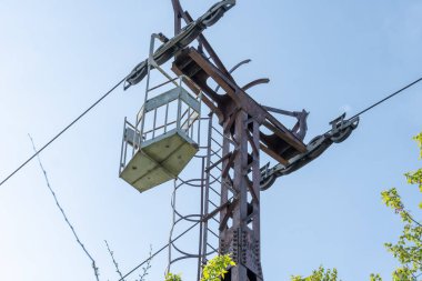 İnsanları eğlence parkına taşımak için terk edilmiş bir kablo. Nehrin karşısındaki eski, eski asma yol. Dnepr şehrinde eski paslı teleferik. Sovyetler Birliği teknolojisi ve çekimleri SSCB.