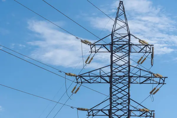 stock image Electricity transmission towers and power lines in blue sky. Detail high voltage pole. Energy concept of industry. Communications and power supply. Crisis and problems in energy sector. Infrastructure