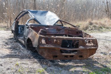 Yakın planda yanmış ve paslı bir araba. Kaza ve felaket sonucu hasar görmüş bir otomobil. Çalıntı ve sonradan terk edilmiş eski bir ulaşım suçu. Acil durum kundaklama ve itfaiye arabası sigortası.