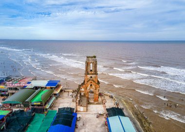 HAI HAU, NAMDINH, VIETNAM, 30 JUNE 2024: REMAINS OF AN OLD CHURCH BY THE SEA DUE TO SALINIZATION clipart