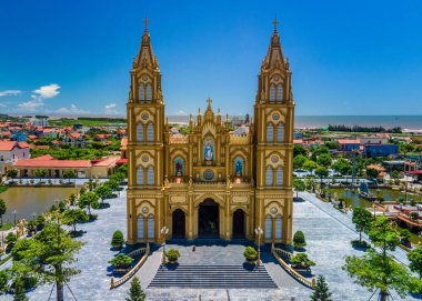 AERIAL VIEW OF XUONG DIEN CHURCH BY THE SEA. Xuong Dien Church is a very beautiful church built by the sea in Hai Hau district, Namdinh province, Vietnam. Interior furniture are plated with real gold.  clipart