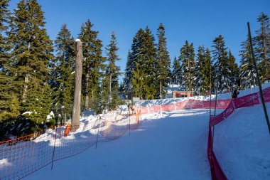 Vancouver, Canada - December 16,2022: View of the Grouse mountain sliding zone at the Peak of Vancouver on sunny day. The Sliding Zone is family fun for all ages