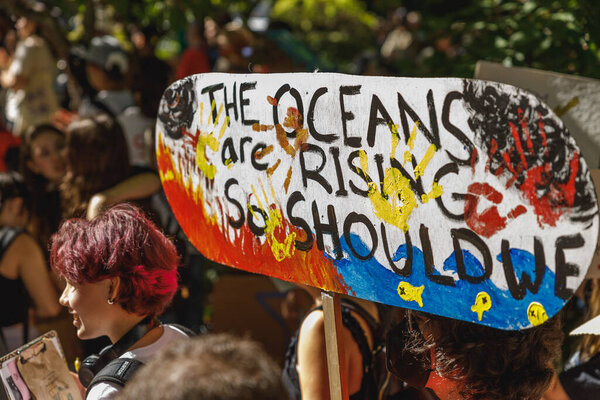 Vancouver, Canada - September 15,2023; View of sign The oceans are rising so should we as part of Global Climate Strike in front of Vancouver City Hall