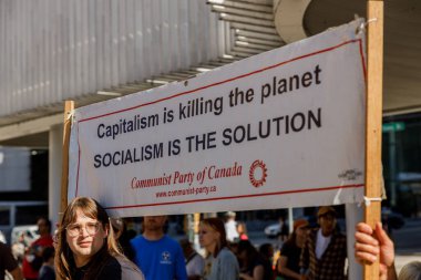 Vancouver, Kanada - 15 Eylül 2023: Bir işaretle aktivist: CAPITALISM gezegeni öldürüyor, SOCIALISM Vancouver 'daki küresel iklim grevinin bir parçası olarak çözüm