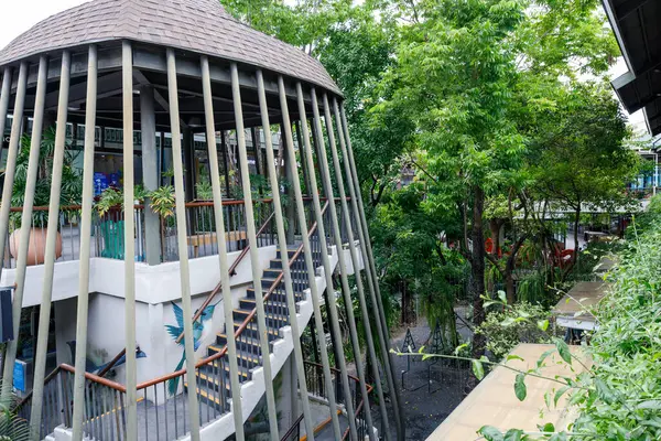 stock image Ko Samui, Thailand - July 11,2024:A unique, open-air architectural structure inside Central Samui, featuring a spiral staircase surrounded by greenery