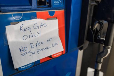 Handwritten note on gas pump stating 