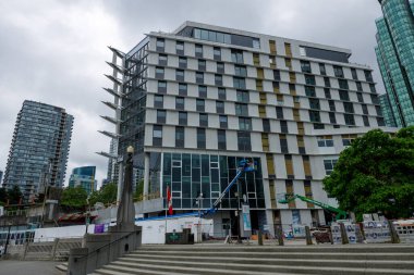 Vancouver, Kanada - 15 Haziran 2015: Coal Harbour İlköğretim Okulu 'nun yeni inşaat alanı, cam cephe, vinç ve kaplanmış malzemelerin yer aldığı modern bir bina