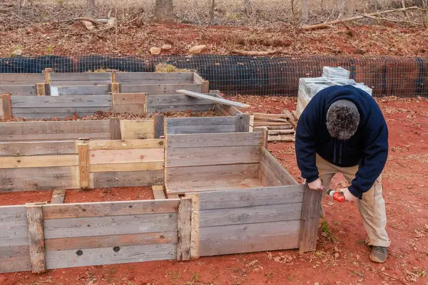 Construction of a raised garden bed frame made of wood.