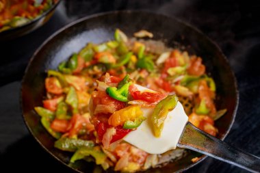 Fresh tomatoes and various bell peppers being saut ed together in skillet, creating vibrant and flavorful vegetable dish. Mixture colorful and aromatic. clipart