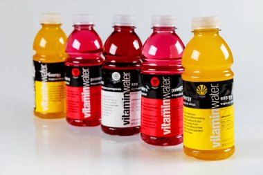 July 6, 2023. Spartanburg, SC USA. Bottles of Vitamin water various flavored hydration drinks lined up in a vibrant display. clipart