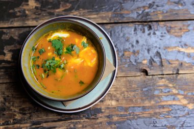 Colorfull Pumpkin soup on old brown wooden table