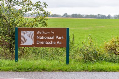 Drouwen, The Netherlands - October 15, 2022: Placename sign National Park Drenthe Drentsche Aa with pasture in background in Drenthe The Netherlands