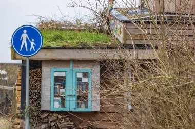 Olst Wijhe, The Netherlands - January 21, 2023: Library box at Self-build earth houses a sustainable circular and nature inclusive neighbourhood in Olst Wijhe in Overijssel The Netherlands