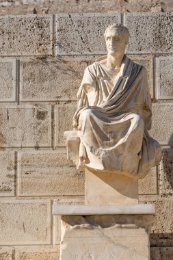 Athens, Greece: September 24, 2021: Antique statue of Menander, the ancient Greek playwright and comedian below the Acropolis site on a sunny evening in Athens in Greece
